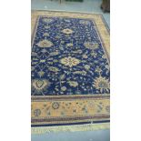 Royal Keshan rug, the blue field with allover foliate design within flowerhead border, 274 x 366cm