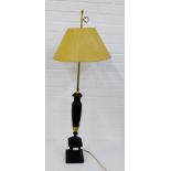 A brass and black painted wooden table lamp of tall proportions on a square plinth base, height