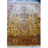 An Eastern rug, the gold field with allover foliate design and flower head border, 370 x 275cm