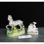 A Staffordshire Zebra, together with a girl and spaniel miniature figure group, tallest 13cm, (2)