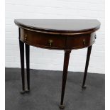 A mahogany fold over table, with two frieze drawers and raised on tapering supports with pad feet,