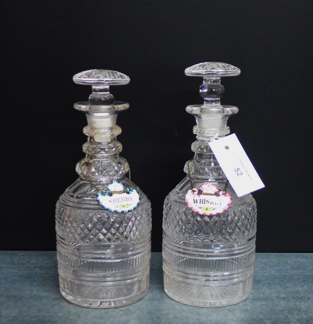 A pair or triple ring neck decanters with flat stoppers and enamelled sherry and whiskey decanter
