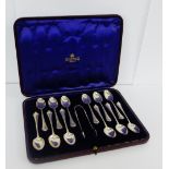 A cased set of twelve Edwardian London silver teaspoons with matching sugar tongs.