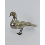 An Iranian silver bird figure, with engraved feather pattern and fan tail, stamped VIGE, 13cm high