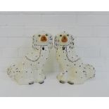 A pair of Staffordshire chimney spaniels, 31cm high, (2)