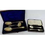 A cased set containing a pair of Victorian Sheffield silver bright cut serving spoons and a