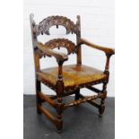 An oak open armchair with carved horizontal splats and worn leather seat, , 98 x 58cm