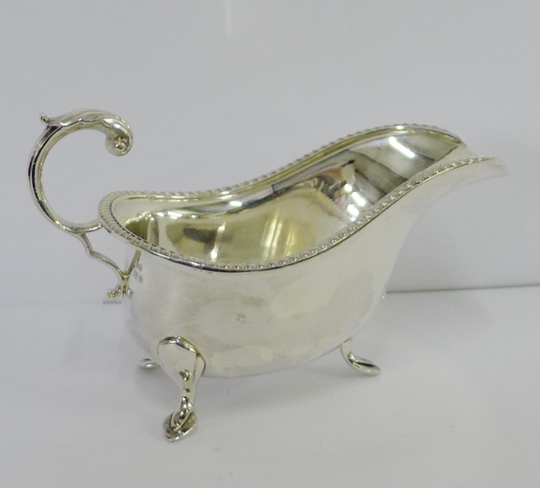 Birmingham silver sauce boat on three hoof feet with mark for Hampton Utilities, 18cm long