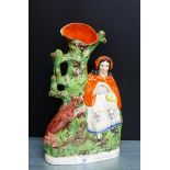 A Staffordshire flatback 'Little Red Riding Hood' spill vase on an oval gilt lined base, 32cm high