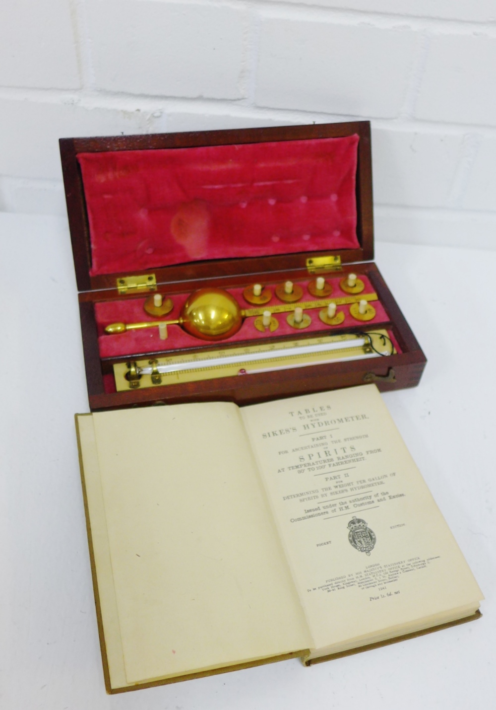 A Sykes Hydrometer in a fitted case together with Spirit Tables Pocket Edition book, (2)