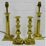 A pair of brass table lamp bases, together with a pair of knop stemmed brass candlesticks, (4)