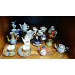 A mixed lot of miniature porcelains to include cups, saucers, vases, etc., together with a small