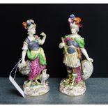A pair of gold anchor porcelain figures of Minerva and Juno, each modelled standing upon a on Rococo