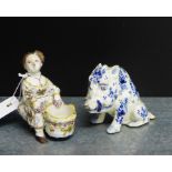 A continental Faience figure of a seated female with a tub at her feet, together with a Delft blue