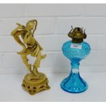 A mixed lot to include a blue glass oil lamp, together with a resin figure, (2)