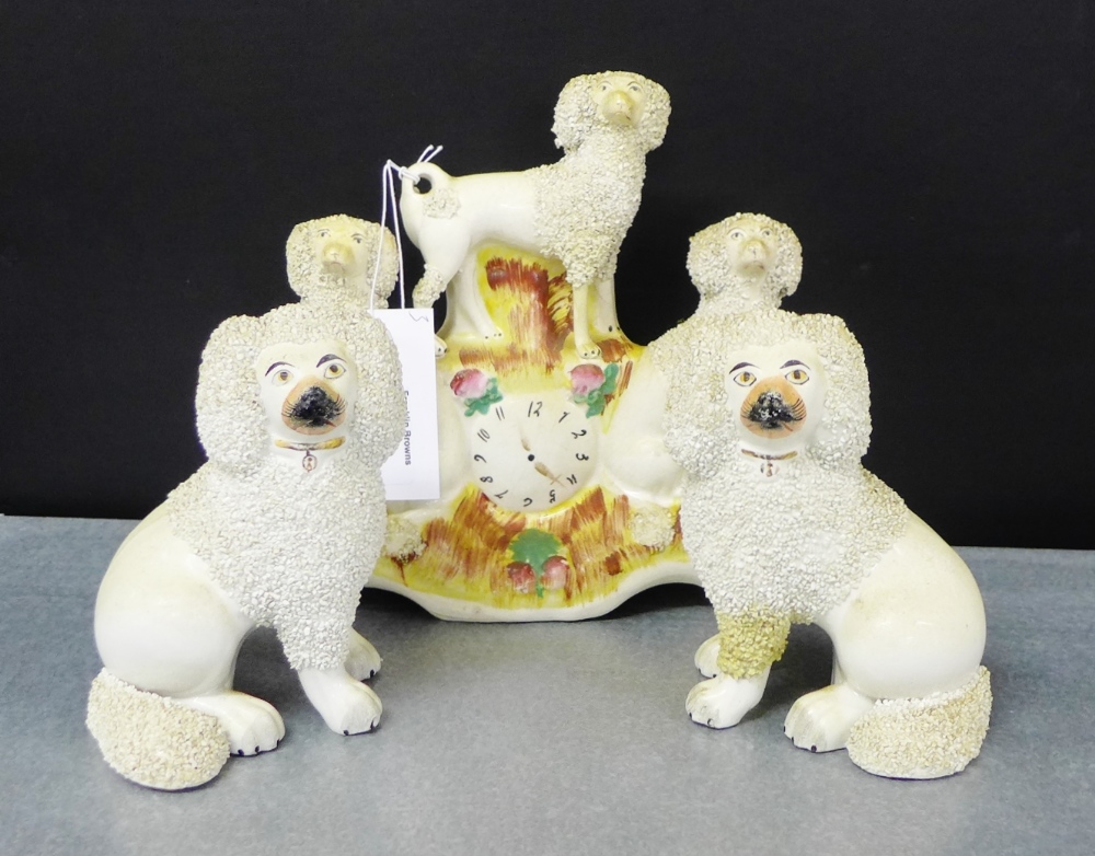 A pair of Staffordshire white glazed seated spaniels, together with a clock and sheep flatback, (