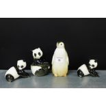 A group of three Russian porcelain Panda Bear figures, together with a Russian pottery Penguin