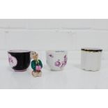 A group of three small porcelain demi tasse cups, together with a bisque nodding head figure, (4)