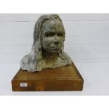 A stoneware head and shoulders composite bust of a girl on a square wooden plinth base, 35cm high