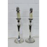 A pair of matched George V silver candlesticks, converted to table lamp bases, bearing makers