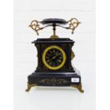 A German black slate mantle clock the circular dial with Roman numerals and flanked by lion mask