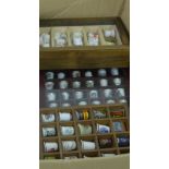 A large collection of showcases containing miscellaneous porcelain thimbles (a large lot)