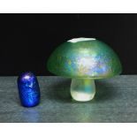 An iridescent green glass Toadstool, together with a small purple glass Owl, tallest 8cm, (2)