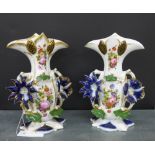 A pair of continental porcelain floral patterned twin handled vases with hand painted floral