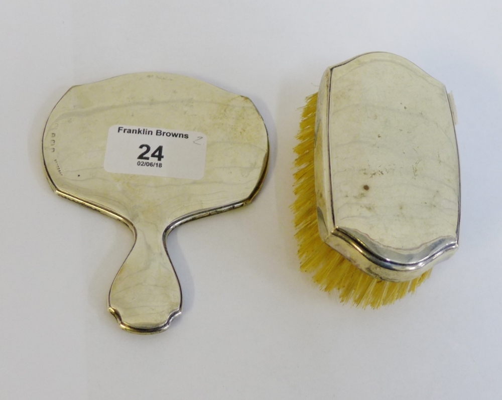 A miniature silver backed hand mirror and clothes brush, Birmingham 1926 (2)