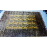 A Bokhara style rug, the golden field with three rows of six medallions, 320 x 210cm