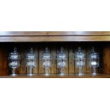 A set of six clear glass goblet shaped jar and covers with knop stems, 30cm high, (6)