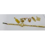 A mixed lot of gold pendants and charms to include two 9 carat pendants, 9 carat T-bar, 9 carat