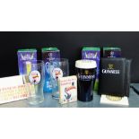 A collection of Guinness memorabilia to include a money bank, pink glasses, apron, playing cards and