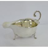 An Edwardian silver cream jug on three hoof feet, London 1908