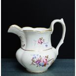 A 19th century English pottery jug with hand painted floral sprays and gilt edged rim, 21cm high