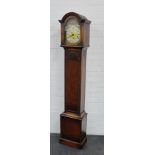 An oak cased grandmother clock, with brass dial and silvered chapter ring with Roman numerals, 68