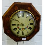 An octagonal wall clock, the painted dial with Roman numerals, complete with weights etc.