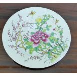 A Japanese porcelain plate painted with prunus and chrysanthemum pattern, 26cm wide