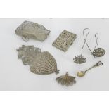 A collection of white metal filigree items to include a card case, wall pocket, fan shaped brooch