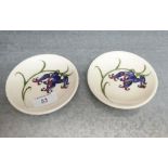 Pair of Moorcroft circular pin dishes, tube line decorated with blue flowers to a cream ground,