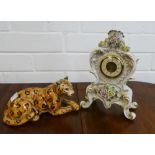 Szeiler Leopard, 21cm long, together with a continental porcelain Rococo style mantle clock, (2)