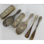 A collection of various silver backed brushes and two silver handled shoe horns (6)