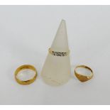 Three 9 carat gold rings to include a wedding band, heart shaped signet ring and a CZ set dress ring