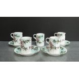 Japanese porcelain teaset with bamboo and blossom pattern, comprising four saucers and five cups, (