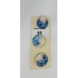 Three ceramic buttons painted with meadow flowers, 2.5cm wide, (3)