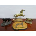 Spelter figure of a Whippet, a painted wooden plaque, together with two brass horse figures, (4)