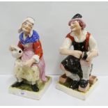 Pair of Staffordshire Male and Female figures, each modelled seated on square plinth bases, 30cm