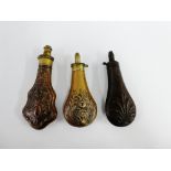 Collection of three powder flasks to include a Sykes Patent and two others with anthemion and