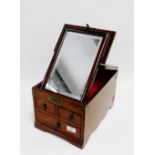 Oak and brass bound jewellery box the hinged top opening to reveal a mirrored panel over two short