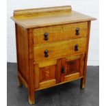 Early 20th century oak ledgeback chest of small proportions, with two drawers above a pair of